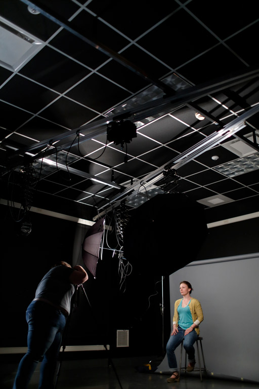 A person taking a photo in a photo studio.
