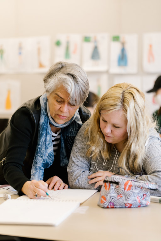 Two people drawing.
