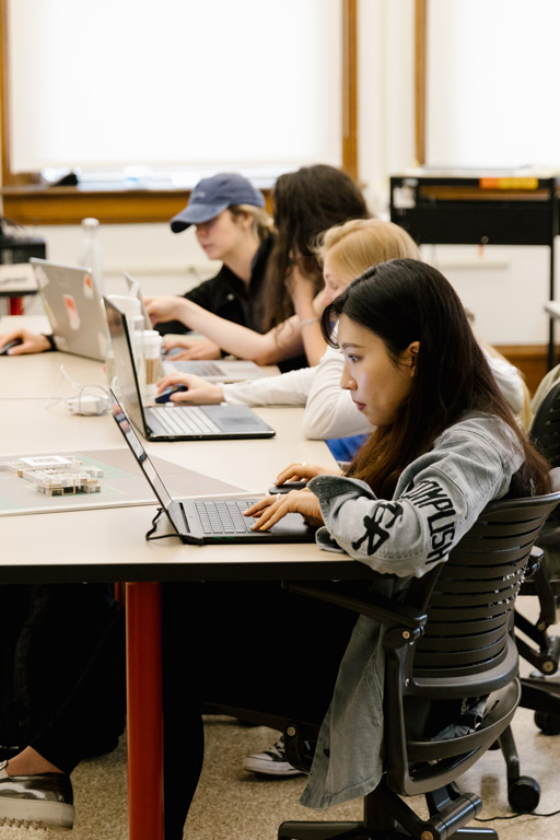 Four students working on computers.