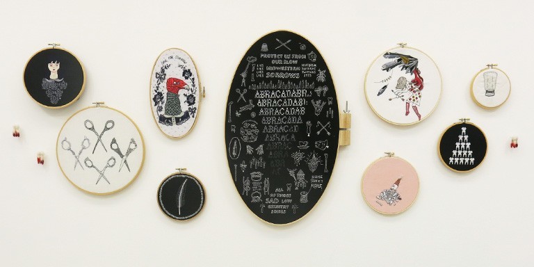 A series of oval art pieces on a wall.