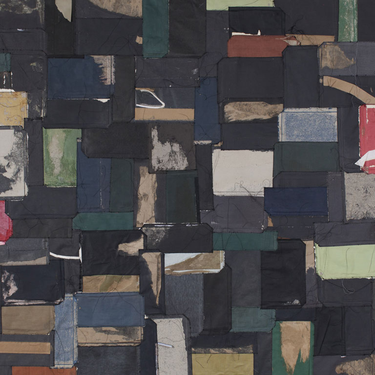 Small pieces of muted colored fabric collaged together by sewing.