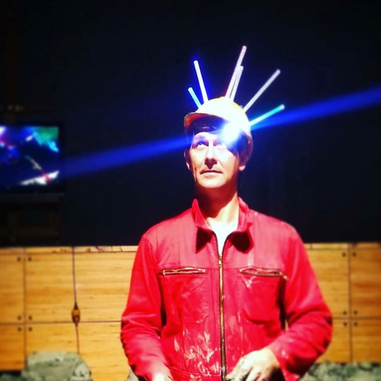 A photo of a person wearing lights on their head.