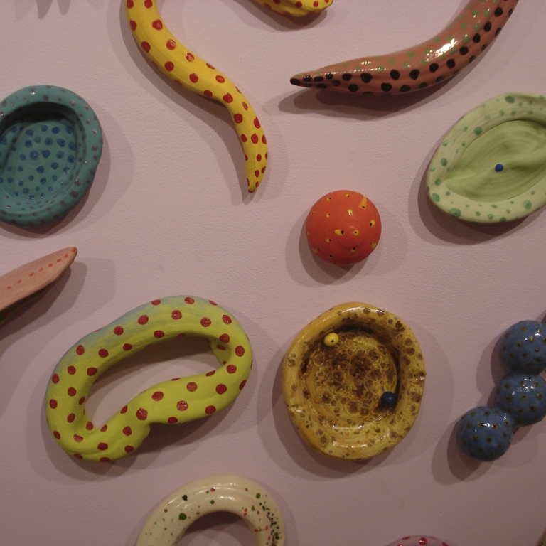 A series of colorful ceramic art pieces.