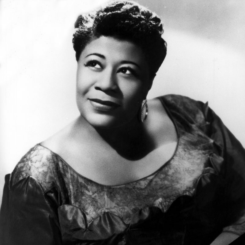 A person (Ella Fitzgerald) smiles away from the camera. 