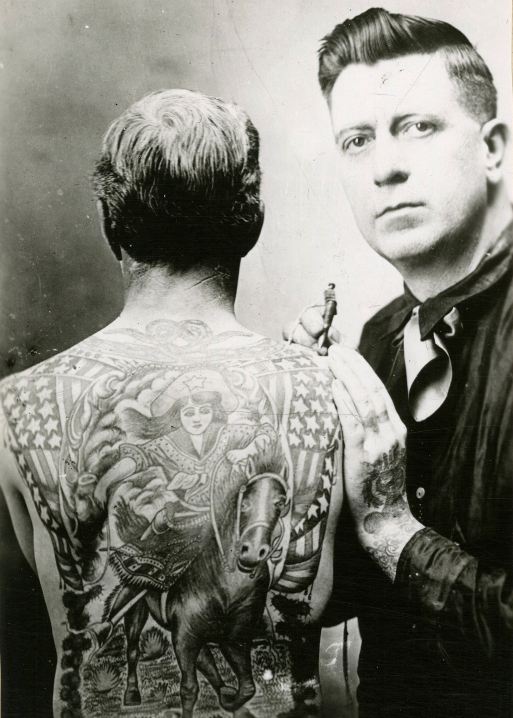 A man with tattoos on his back. 