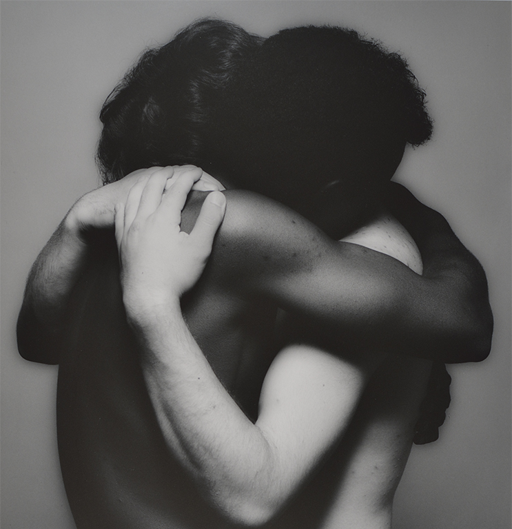 Two people embrace.